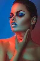 Sexy woman with make up and closed eyes in red and blue lights photo