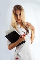 Slim sexy nurse seduce in studio photo