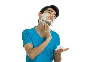 young guy shaving his face with foam
