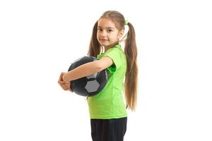 cheerful little girl with soccer ball in hands looking at the camera photo