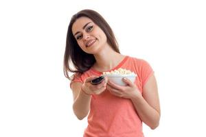 Cheerful woman with tv remote and pop-corn watching movies photo