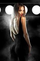 glamour young lady with red lips in tight black suit looking at the camera photo