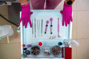 dentist's hands in gloves and dental treatment tools photo