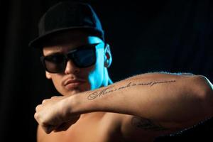 nice man with tattoo on hand in studio photo
