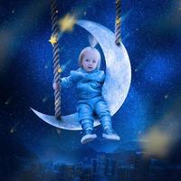 Cute little girl sits on the moon above the city and looks on the stars photo