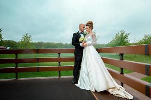 Attractive young married couple in wedding suits photo