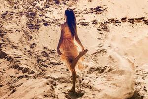 cutie young girl in pink dress in desert photo