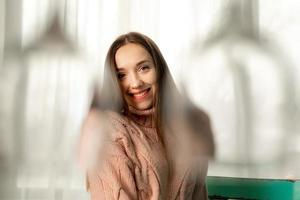 portrait of cheerful woman smiles on camera behind the glasses photo