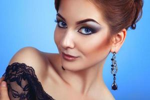 Glamour young adult person with make up on blue background photo