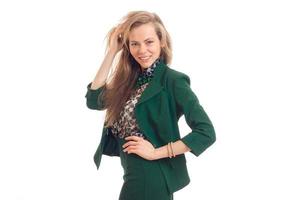 Beautiful blonde business woman smiling on camera in green uniform photo
