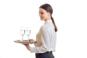 Cutie young waitress smiles and holds a trey photo