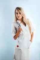 Color image of beauty blonde adult nurse with stethoscope photo