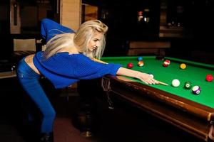 Glamour beautiful blonde woman plays billiard photo