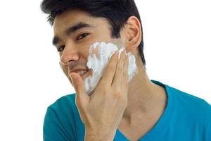 cute guy putting a foam face before shaving photo