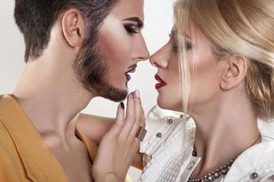Couple in love kissing. Both with makeup. Passion. Seduction. photo