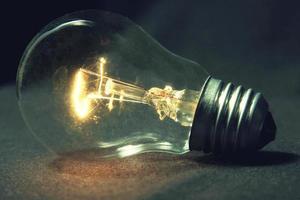the light bulb glows without wires on the table. photo