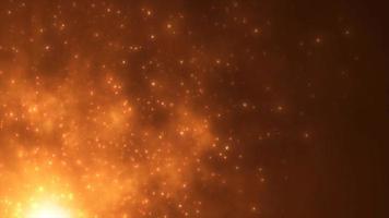 Abstract orange fiery flame bonfire of particles and sparks glowing beautiful magical on a dark background. Abstract background. Video in high quality 4k, motion design