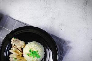 Hainanese chicken rice with soup or steamed chicken and sauces. photo