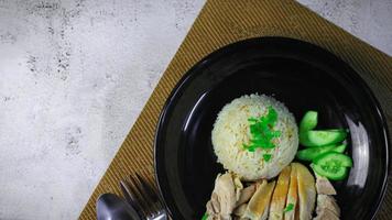 Hainanese chicken rice with soup or steamed chicken and sauces. photo
