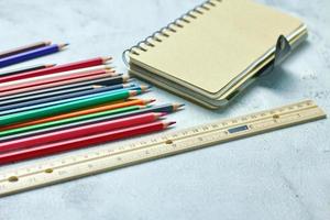 Wooden crayons scattered on the table, wooden rulers and notebooks with the festival back to the semester, students go to school, art lessons. photo