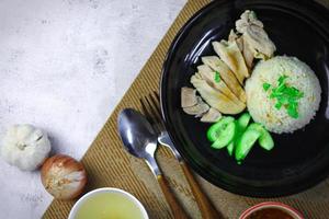 Hainanese chicken rice with soup or steamed chicken and sauces. photo