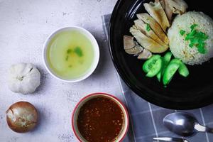 Hainanese chicken rice with soup or steamed chicken and sauces. photo