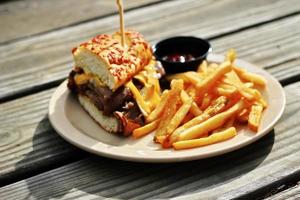 THE PRIME RIB DIPPER Food from applebee's restaurant served on a brown wooden table. sunny morning photo