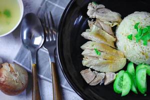 Hainanese chicken rice with soup or steamed chicken and sauces. photo