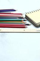 Wooden crayons scattered on the table, wooden rulers and notebooks with the festival back to the semester, students go to school, art lessons. photo