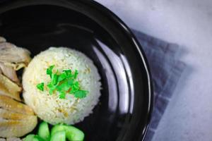Hainanese chicken rice with soup or steamed chicken and sauces. photo