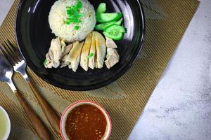 Hainanese chicken rice with soup or steamed chicken and sauces. photo