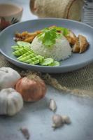 Hainanese chicken rice with fried chicken, fried chicken served with sweet dipping sauce and chicken broth, Asian style, street food commonly sold in Asia. photo