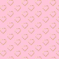 el signo de patrón de corazón dorado brilla aislado sobre fondo rosa. símbolo del día de san valentín. ideal para tarjetas de san valentín y del día de la madre, invitaciones de boda, carteles de fiestas y volantes vector
