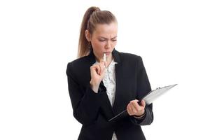 serious sexy business woman holds the handle near the mouth and looks into the Tablet is isolated on a white background photo