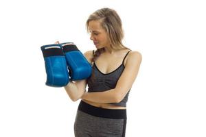 a young athlete holds boxing gloves photo