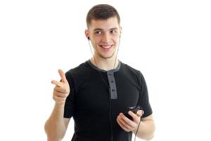 delightful, charming young man holding a telephone and posing for the camera photo