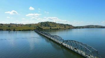 The aerial drone point of view footage at The Bethanga Bridge is a steel truss road bridge that carries the Riverina Highway across Lake Hume, an artificial lake on the Murray River.