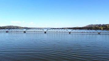 The aerial drone point of view footage at The Bethanga Bridge is a steel truss road bridge that carries the Riverina Highway across Lake Hume, an artificial lake on the Murray River. video