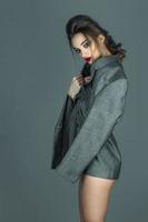 beautiful girl only in gray jacket with nice make up and hairdtyle photo