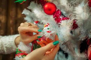 Close up photo of toy snowman on tree