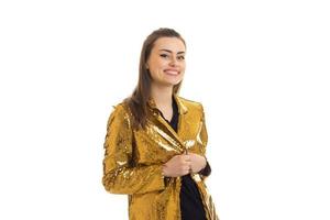 a cheerful young girl in a bright shiny jacket in Studio photo