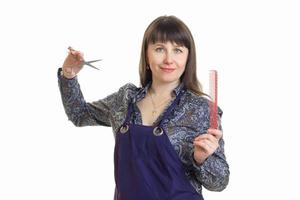 cheerful woman stylish in apron holds a tool and smiles photo