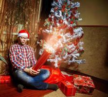 Square portrait of happy nerd with a lot of christmas presents photo