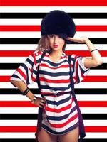pretty girl in furhat on stripes background photo