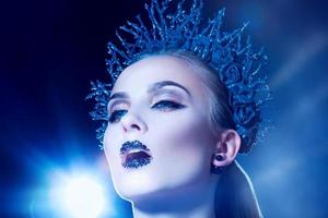 Serious sensual young adult woman with wreath in studio photo