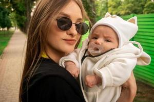 portrait of mom with her newborn daughter photo