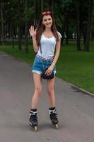 joyful girl stands on the roller arm waving and smiling photo