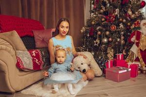 young mother with little baby girl celebrate Christmas photo