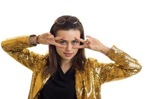 Cute young stylish girl in golden jacket posing on camera photo