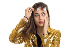 a close-up portrait of young girl in a brilliant jacket and glasses photo